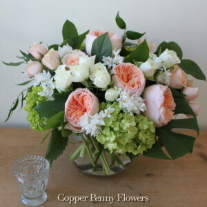 Peach Veranda Premium Flower Arrangement from Copper Penny Flowers features garden roses, spray roses, and green hydrangea