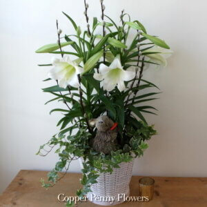 Easter Lily basket features a flowering plant with pussy willows and bunny