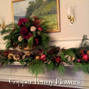 holiday mantel floral designs featuring evergreens, roses, and natural and metallic accents