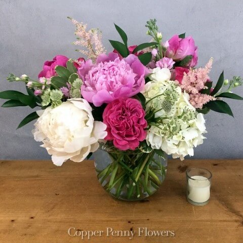Warm Wishes flower arrangement features lavish pink and white blooms in a glass bowl