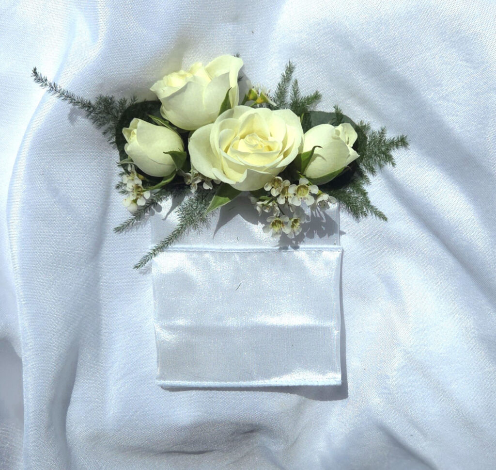 The Pocket Square features premium blooms with accents designed to slide into a pocket to give a decorative border.