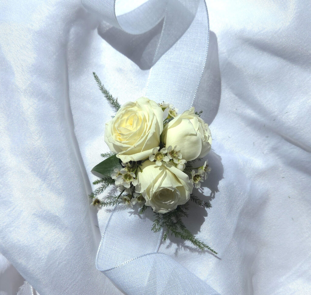 A Corsage features premium blooms with greenery on a ribbon to fit all wrist sizes