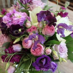 hand-held bouquet of purples, pinks, and whites