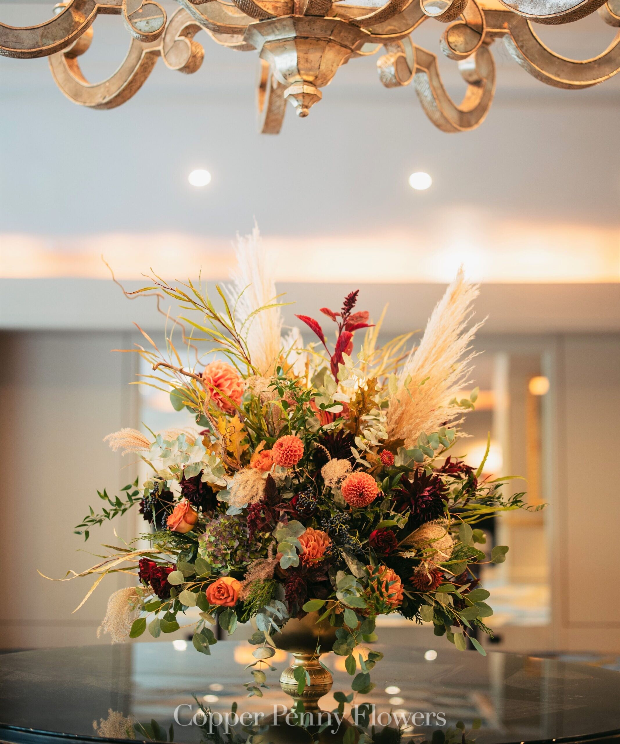Dramatic ceremony floral centerpiece in autumn-hued tones