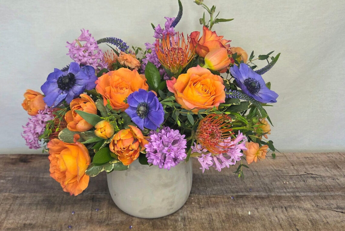 In The Mood is an orange and purple design featuring roses, anemones, and hyacinth
