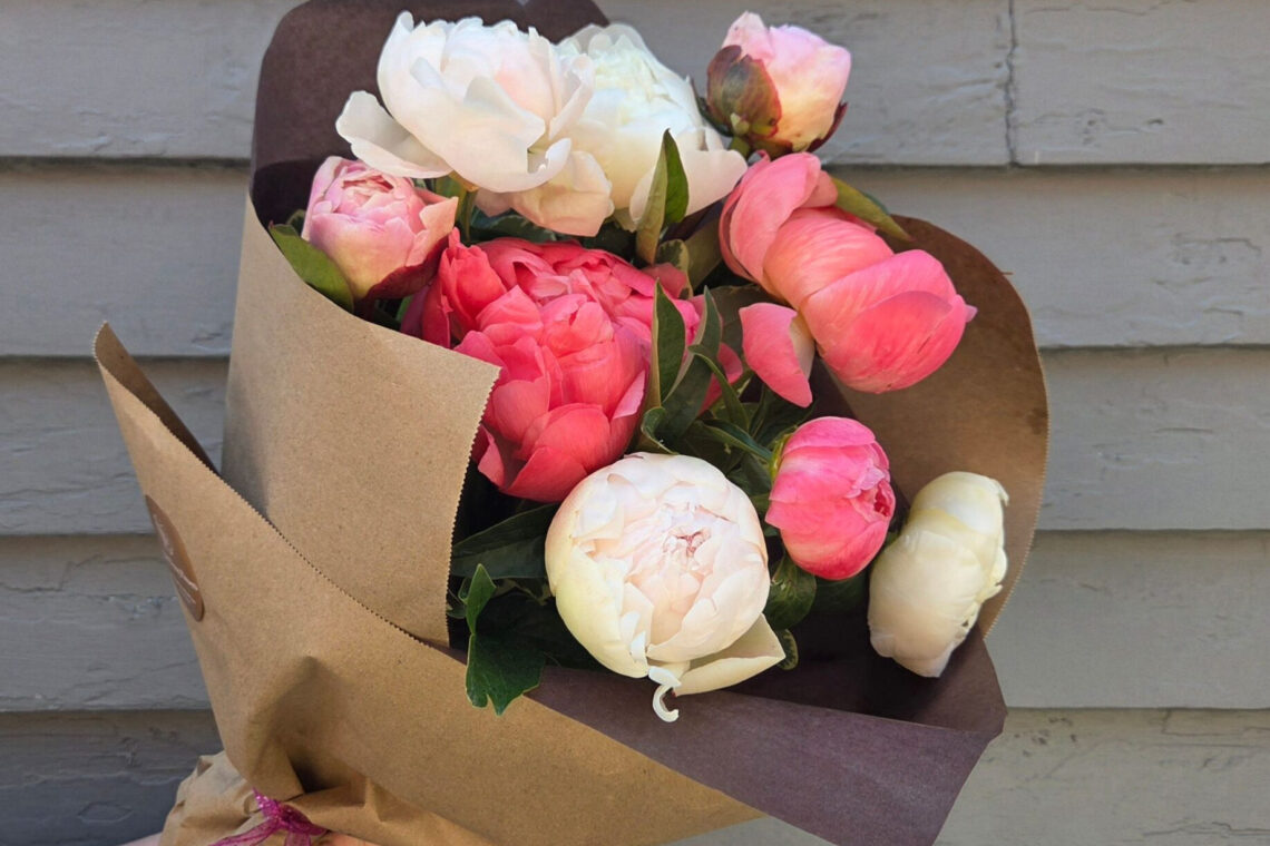 June Swoon Bouquet is a selection of peonies with premium greens wrapped with a water source