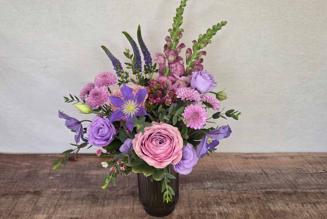 Mauve Music is a pink, lavender, and mauve flower arrangements featuring snap dragons, lisianthus, and clematis.