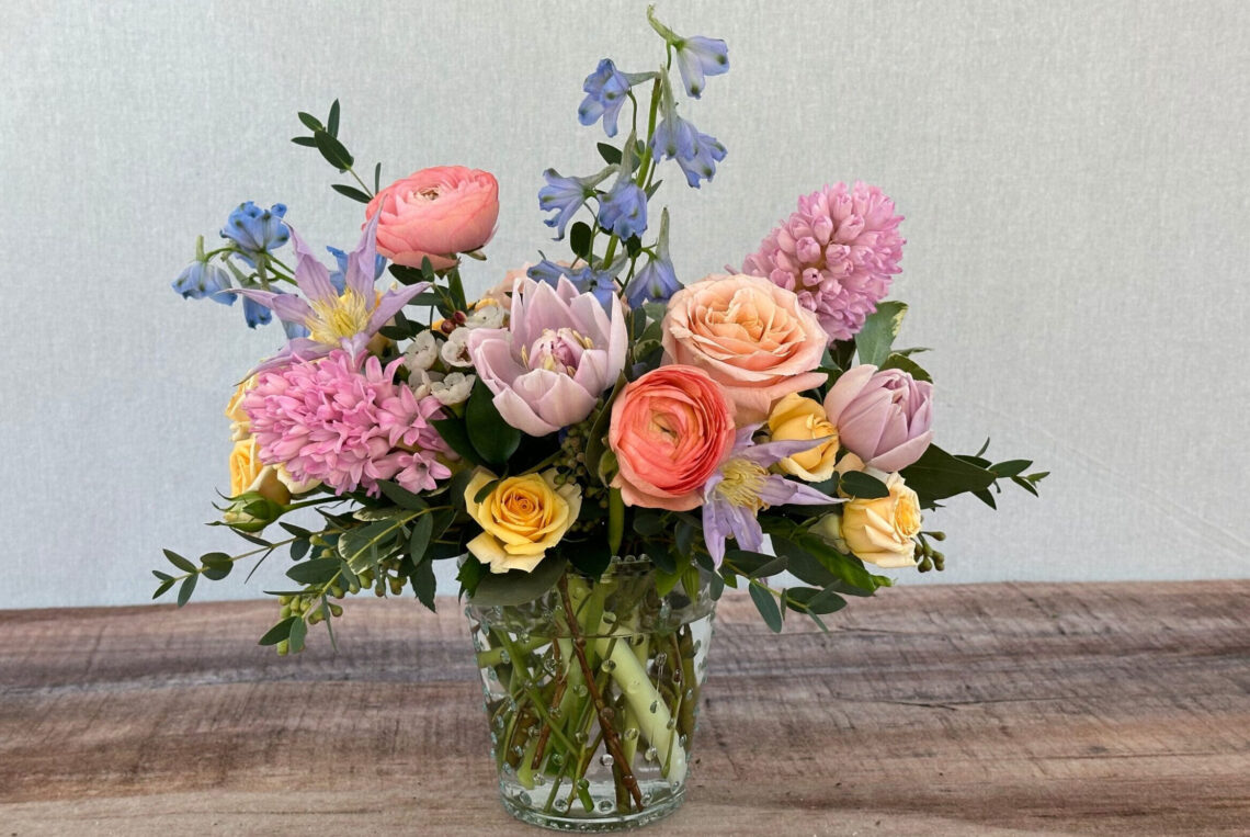 Spring Designer's Choice is a pastel mix of blooms in a glass vase that could include hyacinth, tulips, daffodils