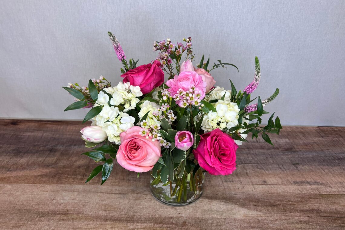 Designer's Choice Valentine is a flower arrangement made featuring a selection of white, pink, and red blooms