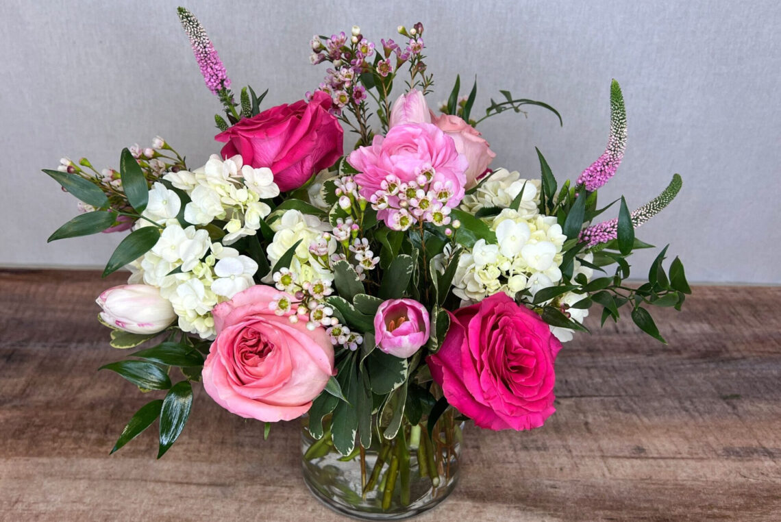 Designer's Choice Valentine is a flower arrangement made featuring a selection of white, pink, and red blooms